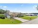 Charming home with a spacious driveway, manicured shrubs, and a well-maintained lawn, perfect for curb appeal at 22852 Fern Ct, Land O Lakes, FL 34639