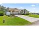 Charming home featuring a well-manicured lawn, a spacious driveway, and an inviting two-car garage at 22852 Fern Ct, Land O Lakes, FL 34639