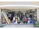 A cluttered two-car garage filled with tools and storage items at 22852 Fern Ct, Land O Lakes, FL 34639