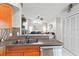 Open kitchen featuring stainless steel appliances, updated sink, and tile floors at 22852 Fern Ct, Land O Lakes, FL 34639
