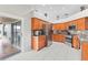 Bright kitchen with stainless steel appliances, tile floors, and a sliding glass door at 22852 Fern Ct, Land O Lakes, FL 34639