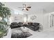 Bright living room featuring vaulted ceilings, tile flooring, and a large sectional sofa at 22852 Fern Ct, Land O Lakes, FL 34639