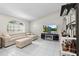 Well-lit living room showcasing a plush sectional sofa, modern decor, and a sleek entertainment center at 22852 Fern Ct, Land O Lakes, FL 34639