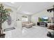 Inviting living room with light-colored tile, a modern TV console, and a comfortable sectional sofa at 22852 Fern Ct, Land O Lakes, FL 34639