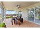 Outdoor covered patio featuring tile floor, ceiling fan, and wood table with seating at 22852 Fern Ct, Land O Lakes, FL 34639
