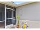 Exterior shot of back patio with outdoor chairs and a small potted plant at 22852 Fern Ct, Land O Lakes, FL 34639