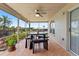 Outdoor covered patio featuring tile floor, ceiling fan, and wood table with seating at 22852 Fern Ct, Land O Lakes, FL 34639