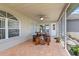 Outdoor covered patio featuring tile floor, ceiling fan, and wood table with seating at 22852 Fern Ct, Land O Lakes, FL 34639