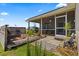 Exterior shot of back patio with outdoor chairs and a small grill at 22852 Fern Ct, Land O Lakes, FL 34639