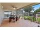 Outdoor covered patio featuring tile floor, ceiling fan, and wood table with seating at 22852 Fern Ct, Land O Lakes, FL 34639