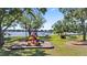 View of the community playground with a slide, picnic tables, and views of the lake at 22852 Fern Ct, Land O Lakes, FL 34639