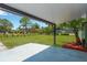 Relaxing backyard with green grass, a patio, and a shade-providing overhang at 2303 E Osborne Ave, Tampa, FL 33610