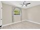Bedroom featuring modern floors and neutral paint with a view of the backyard at 2303 E Osborne Ave, Tampa, FL 33610