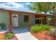 Welcoming entrance showcasing a covered porch and well-maintained landscaping at 2303 E Osborne Ave, Tampa, FL 33610