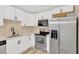 Well-equipped kitchen showcasing stainless steel appliances and ample storage space at 2303 E Osborne Ave, Tampa, FL 33610