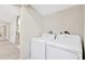 Bright laundry room featuring a washer and dryer hookup with easy access at 2303 E Osborne Ave, Tampa, FL 33610