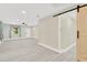 Spacious living room featuring modern floors, neutral paint, and natural lighting at 2303 E Osborne Ave, Tampa, FL 33610