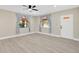 Bright living room boasting new flooring, fresh paint, and modern ceiling fan at 2303 E Osborne Ave, Tampa, FL 33610