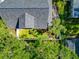 Overhead view of a home's roof, screened-in patio, fenced-in yard, and lush surrounding landscaping at 2311 64Th Street W Ct, Bradenton, FL 34209