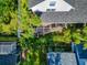 Aerial view of a home, with an outdoor patio, screened-in porch, and verdant landscaping at 2311 64Th Street W Ct, Bradenton, FL 34209