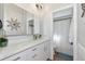 Modern bathroom features a sleek vanity with quartz countertop, brushed nickel hardware, and triple mirrored medicine cabinet at 2311 64Th Street W Ct, Bradenton, FL 34209