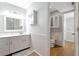 Well lit bathroom featuring bright white cabinets, gray accents, and wood flooring at 2311 64Th Street W Ct, Bradenton, FL 34209