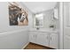 Elegant bathroom with white cabinets, a marble countertop, and modern lighting at 2311 64Th Street W Ct, Bradenton, FL 34209