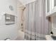 Bright bathroom with white tile and a shower and tub combo with gray towels and decorative accents at 2311 64Th Street W Ct, Bradenton, FL 34209