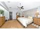 The primary bedroom is spacious with a modern ceiling fan, neutral walls, and a walk-in closet to the side at 2311 64Th Street W Ct, Bradenton, FL 34209
