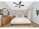 The primary bedroom is spacious with a modern ceiling fan, neutral walls, and french doors to the backyard at 2311 64Th Street W Ct, Bradenton, FL 34209