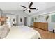The primary bedroom is spacious with a modern ceiling fan, neutral walls, and french doors to the backyard at 2311 64Th Street W Ct, Bradenton, FL 34209