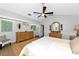 The primary bedroom is spacious with a modern ceiling fan, neutral walls, and two dressers at 2311 64Th Street W Ct, Bradenton, FL 34209
