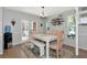 Bright dining room with white wooden table and bench seating, complemented by a decorative rug and wall shelves at 2311 64Th Street W Ct, Bradenton, FL 34209
