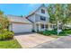 Two-story home with attached garage, front porch, and brick paver driveway at 2311 64Th Street W Ct, Bradenton, FL 34209