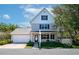 Charming two-story home with a well-manicured lawn, attached garage, and inviting front porch at 2311 64Th Street W Ct, Bradenton, FL 34209