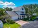 Beautiful two-story home with a manicured lawn, mature trees, and a spacious driveway leading to the garage at 2311 64Th Street W Ct, Bradenton, FL 34209