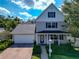 Charming two-story home with a well-maintained front yard, brick driveway, and covered front porch at 2311 64Th Street W Ct, Bradenton, FL 34209