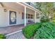 Inviting front porch with brick walkway, decorative door, and lush landscaping at 2311 64Th Street W Ct, Bradenton, FL 34209