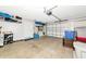 Bright, spacious garage with a roll-up door, storage shelves, and plenty of open floor space at 2311 64Th Street W Ct, Bradenton, FL 34209