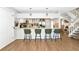 Bright kitchen with white cabinets, stainless steel appliances, bar seating, and modern lighting at 2311 64Th Street W Ct, Bradenton, FL 34209