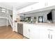 Bright, open kitchen with white cabinets, stainless steel appliances, and a view into the living area at 2311 64Th Street W Ct, Bradenton, FL 34209