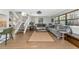 Bright living room featuring wood floors, a large rug, and a staircase with white risers and railings at 2311 64Th Street W Ct, Bradenton, FL 34209