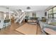 Bright living room showcasing wood floors, neutral decor, a staircase, and comfortable seating at 2311 64Th Street W Ct, Bradenton, FL 34209