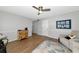 Spacious living room with wood flooring, neutral colors, and a vintage cabinet at 2311 64Th Street W Ct, Bradenton, FL 34209