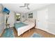Bright primary bedroom with hardwood floors, a ceiling fan, and ample closet space at 2311 64Th Street W Ct, Bradenton, FL 34209