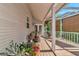 Outdoor patio featuring a ceiling fan, sunshades, and outdoor seating surrounded by lush potted plants at 2311 64Th Street W Ct, Bradenton, FL 34209