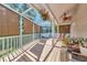 Charming screened patio featuring a ceiling fan, roll-down sunshades, and comfortable seating area at 2311 64Th Street W Ct, Bradenton, FL 34209
