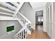 Bright foyer features a white staircase with grey treads and a view to the living area with wood-look floors at 2311 64Th Street W Ct, Bradenton, FL 34209