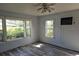 Living room with light blue walls, wood-look flooring, and multiple windows at 2326 Melrose S Ave, St Petersburg, FL 33712