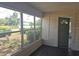 Enclosed porch features multiple windows, a door to the home, and plank flooring at 2326 Melrose S Ave, St Petersburg, FL 33712